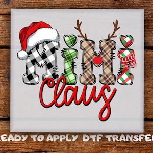 May include: A festive design featuring the words "Mimi Claus" in a playful font. The letters are decorated with Christmas-themed patterns, including a Santa hat, reindeer antlers, and hearts. The text "READY TO APPLY DTF TRANSFER" is at the bottom.