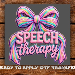 May include: A colorful graphic featuring a large bow with rainbow-colored stripes and the words "SPEECH therapy" in pink, 3D lettering. The phrase "READY TO APPLY DTF TRANSFER" is printed at the bottom.