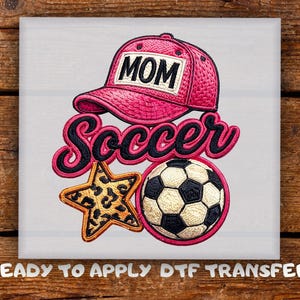 May include: A DTF transfer featuring a pink baseball cap with the text MOM, the word soccer in black script with a pink outline, a gold and black leopard print star, and a black and white soccer ball, all on a white background.