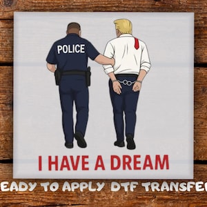May include: A square graphic featuring an illustration of a police officer escorting a person in handcuffs. The person is wearing a white shirt and a red tie. The text "I HAVE A DREAM" is below the illustration.