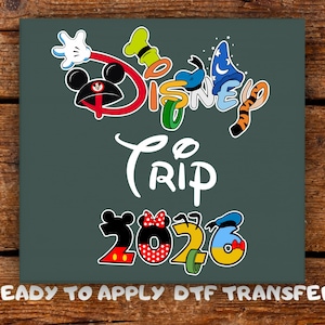 May include: A dark teal graphic featuring the words "Disney Trip 2026" in a colourful, cartoonish font. The word "Disney" is styled with Mickey Mouse ears, Goofy's hat, Donald Duck's hat, and a tiger tail. The text "READY TO APPLY DTF TRANSFER" is at the bottom.