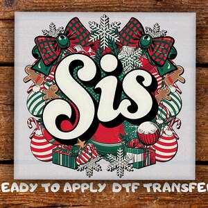 May include: A Christmas design featuring the word "Sis" in a retro font, surrounded by festive elements. The design includes red and green bows, baubles, gingerbread men, and snowflakes. The text "READY TO APPLY DTF TRANSFER" is at the bottom.