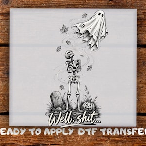 May include: A black and white DTF transfer featuring a skeleton standing with arms crossed, looking up at a floating ghost. A tombstone marked RIP, a jack-o'-lantern, and falling leaves surround the skeleton. The text reads Well, shit...