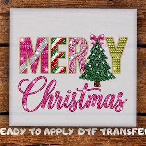 May include: A square DTF transfer featuring the text MERRY CHRISTMAS in a faux rhinestone style. The letters are pink, green, and candy cane striped, with a green Christmas tree replacing the letter A. The text READY TO APPLY DTF TRANSFER is below.