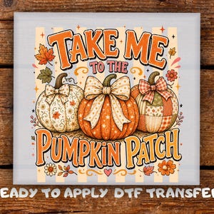May include: A square DTF transfer featuring three pumpkins with bows, surrounded by autumn leaves and flowers. The text reads TAKE ME TO THE PUMP KIN PATCH. The design includes orange, cream, and brown colours with a striped background pattern.