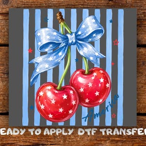 May include: A digital illustration of two red cherries with white star patterns, connected by a stem and a blue bow with white stars. The background features blue stripes and the word "America".