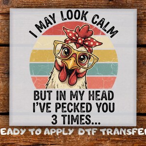 May include: A square image features a chicken wearing glasses and a red polka-dot headscarf, set against a retro sunset design. Text reads "I MAY LOOK CALM BUT IN MY HEAD I'VE PECKED YOU 3 TIMES..."