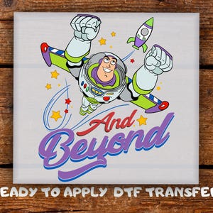 May include: A colorful graphic featuring Buzz Lightyear in flight, with a rocket and stars. The phrase "And Beyond" is written in a stylized font. The image is a ready-to-apply DTF transfer.