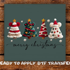 May include: A teal background displays four decorative Christmas tree designs with star toppers and snowflake accents. The cursive phrase "merry christmas" is written below the trees. The words "READY TO APPLY DTF TRANSFER" are at the bottom.