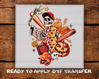 May include: A Halloween-themed graphic featuring a skeleton wearing a baseball cap and sunglasses, holding a baseball bat. The design includes a pumpkin, baseball, lightning bolt, and the text "READY TO APPLY DTF TRANSFER."