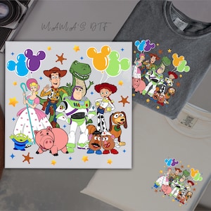 May include: A canvas print and two t-shirts featuring a colourful cartoon design of characters from the Toy Story movie. The canvas print has the text "MAMAS DTF" in a handwritten style. The t-shirts are grey and white.