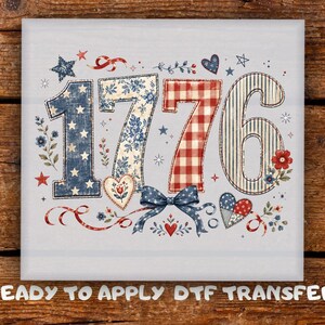 May include: A square DTF transfer featuring the number 1776 in a patriotic style. The digits are decorated with blue star patterns, blue floral prints, red and white gingham, and blue stripes. Accents include hearts, stars, and a blue bow.