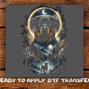 May include: A DTF transfer featuring a Rottweiler head centered within a glowing circular halo against a dark background. Below the head, a smaller Rottweiler stands in a forest scene with a moonlit sky. The text reads READY TO APPLY DTF TRANSFER.