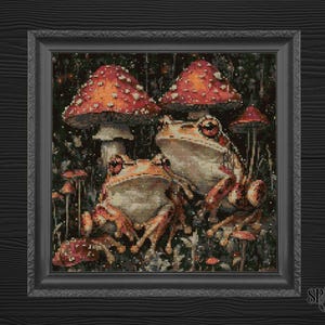 May include: Two frogs sitting on a mushroom with red and white spots. The frogs are green and brown with large eyes. The background is a dark forest with other mushrooms.