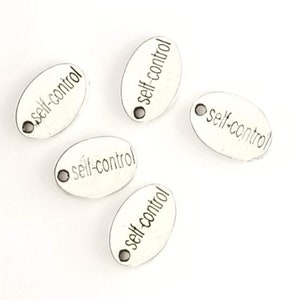 May include: Five silver oval charms with the words "self-control" engraved on them. Each charm has a small hole at the top for attaching to a necklace or bracelet.