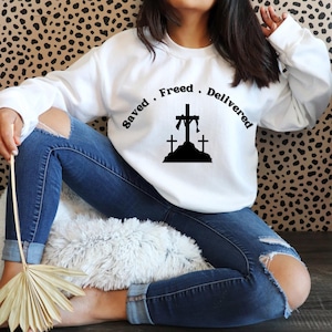 Christian Crewneck Sweatshirt | Saved Freed Delivered | Faith-Based Apparel | Inspirational Jesus Gift Cozy Religious Sweater for Men&Women