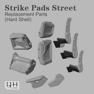 May include: Gray replacement parts for Strike Pads Street (Hard Shell). The image shows various components, including curved and rectangular pieces, and parts with hinges. The text "Strike Pads Street" and "Replacement Parts" is visible.