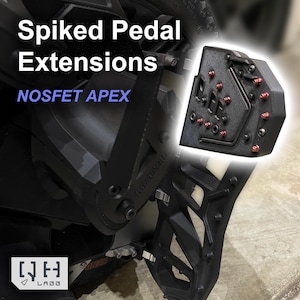 May include: Black spiked pedal extensions with red accents. The image shows the text "Spiked Pedal Extensions" and "NOSFET APEX". The product is designed for use with a vehicle's pedals.