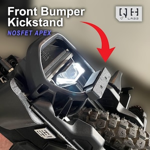 May include: A close-up of a black front bumper kickstand with the text "Front Bumper Kickstand" and "NOSFET APEX". The kickstand is attached to a vehicle with a tire visible in the background. The image also includes the logo "WH LABO".