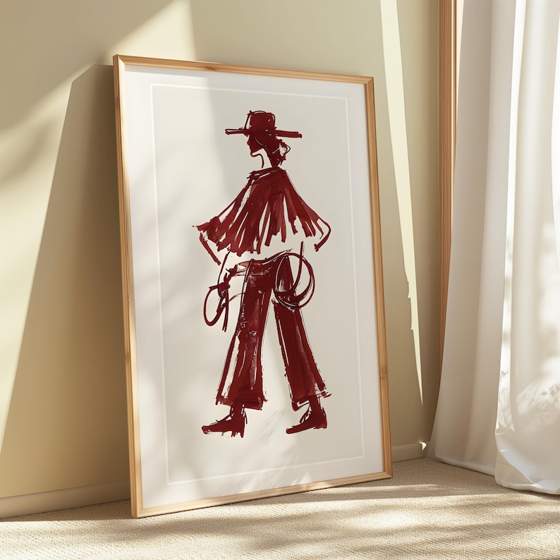 May include: A framed illustration of a person wearing a wide-brimmed hat and a long, flowing cape. The person is drawn in a bold, red ink style.