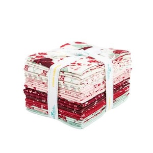 May include: A stack of fabric squares in various shades of red, pink, and white, with floral patterns. The fabric is tied with a white ribbon that has the text "create color". Ideal for quilting and crafting projects.