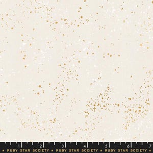 May include: Cream-colored fabric with a speckled pattern of gold and white dots. The fabric has a subtle texture and a ruler along the bottom edge with the text "RUBY STAR SOCIETY".