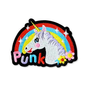 May include: Embroidered patch featuring a white unicorn with a purple mane and a yellow horn, set against a rainbow and stars. The word "Punk" is written in colorful letters. Flowers are on the right side of the unicorn.