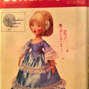 May include: A vintage craft pattern for a porcelain doll wearing a blue dress with white lace trim. The pattern is titled "Soft Porcelain Creations Janet" and is from Butterick, pattern number 4161. The doll is wearing a blue dress with white lace trim and has blonde hair.