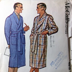 May include: A vintage sewing pattern for a men's robe. The pattern is for a robe with a plaid design and a solid blue robe. The pattern is from McCall's and is size 34-36. The pattern is printed on a white background.