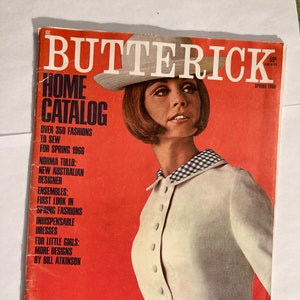 Peut inclure: Une couverture de magazine rouge et blanche avec le titre "Butterick Home Catalog" et une femme portant une robe blanche avec un col à carreaux noir et blanc. La couverture du magazine présente le texte "Over 350 Fashions to Sew for Spring 1966" et "Norma Tullo: New Australian Designer".