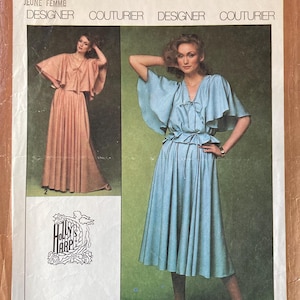 May include: Simplicity sewing pattern number 8646 for a miss or young woman's dress. The pattern includes two different styles, one with a long skirt and one with a shorter skirt. Both styles feature a V-neckline and a tie at the waist. The pattern is printed on a brown background with white text.