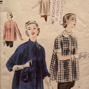 May include: Vintage Vogue pattern 7427-40c showing illustrations of women's jackets. The pattern includes designs for a pink, navy blue, and black and white checkered jacket. The pattern size is medium (81-86 cm).