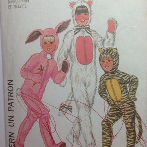 May include: A sewing pattern for three children's costumes. The costumes are a pink bunny, a white cat, and a yellow and black striped tiger. The pattern is from Simplicity and the pattern number is 7683.