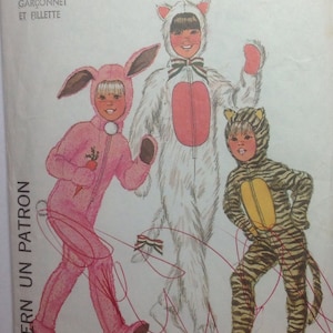 May include: A sewing pattern for three children's costumes: a pink bunny, a white cat, and a striped tiger. The pattern is called "Simplicity 7683" and is for a boy and girl.