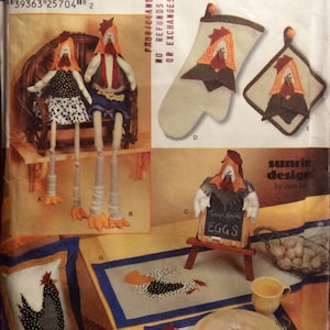 May include: A sewing pattern for kitchen accessories featuring a rooster theme. The pattern includes instructions for making a rooster cushion, a rooster pot holder, a rooster oven mitt, a rooster placemat, a rooster napkin ring, and a rooster chalkboard sign. The pattern is from Simplicity and is labelled "Easy! Kitchen Accessories".