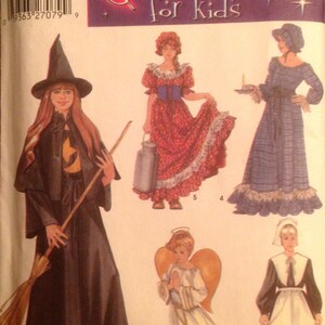 May include: A sewing pattern for children's costumes. The pattern includes five different costumes: a witch, a pioneer girl, a pilgrim girl, an angel, and a colonial girl. The pattern is for sizes 2-4, 6-8, 10-12. The pattern is from Simplicity and the pattern number is 5372.