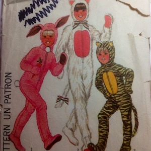 May include: A sewing pattern for three children's costumes: a bunny, a cat, and a tiger. The pattern is called "Simple-to-Sew" and is size 4 for boys and girls.