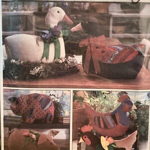 May include: Simplicity craft pattern for stuffed animal toys. The image shows a white goose and a black duck with red accents. Also shown are a pig and a chicken. The pattern is one size.