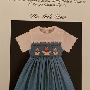 May include: A blue and white smocked dress with a white collar and short sleeves. The dress features a red, white and blue embroidered design of three birds singing. The text "The Little Choir" is printed above the dress. The text "1988, Pat Garretson, Copyright U.S.A." is printed below the dress. The text "#006" is printed in the bottom right corner.