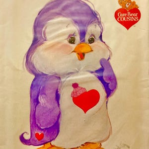 May include: A vintage sewing pattern with a cartoon penguin design. The penguin is depicted in purple and white, with a red heart and a pink hat. The text "Cozy Heart Penguin" is at the top, with the Care Bear Cousins logo and the Butterick logo at the bottom.
