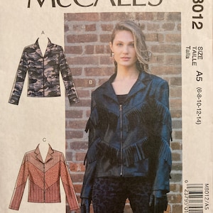 May include: A sewing pattern for a jacket with three different style options. The pattern is for sizes 6-8-10-12-14. The jacket has a zip closure and a collar. The pattern is from McCall's and the pattern number is M8012.