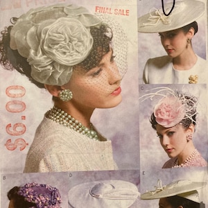 May include: A vintage sewing pattern for five different hat styles. The pattern is for Vogue Accessories and features a white background with black text and illustrations of women wearing the hats. The pattern number is V8052.