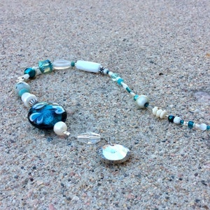 Sun catcher decoration.  Window charm. Teal aqua white. Heart lampwork bead. handmade beaded gift.