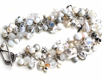 whispers of white. bracelet. wire wrapped bracelet. white beaded wrap bracelet. swarovski. moonstone. pearls. sterling silver clasp.