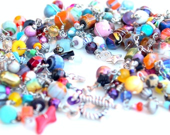 friendship bracelet. layered rainbow. bracelet. multicolored beads. sterling silver clasp. tactile heaven.