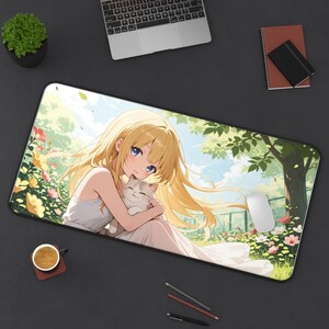 May include: A rectangular desk mat featuring an anime-style illustration of a person with long blonde hair wearing a white dress, holding a small cat in their arms. The scene is set in a sunny garden with green trees, yellow and pink flowers.