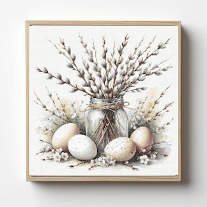 May include: A framed watercolor print featuring a glass jar filled with pussy willow branches. The jar is surrounded by speckled eggs and small white flowers, creating a spring or Easter theme.