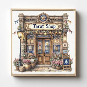 May include: A cross-stitch pattern depicting a storefront with the text Tarot Shop above the entrance. The building features a stone facade, a street lamp, wooden doors, and windows displaying framed art. Potted flowers and a sign with a star sit outside.