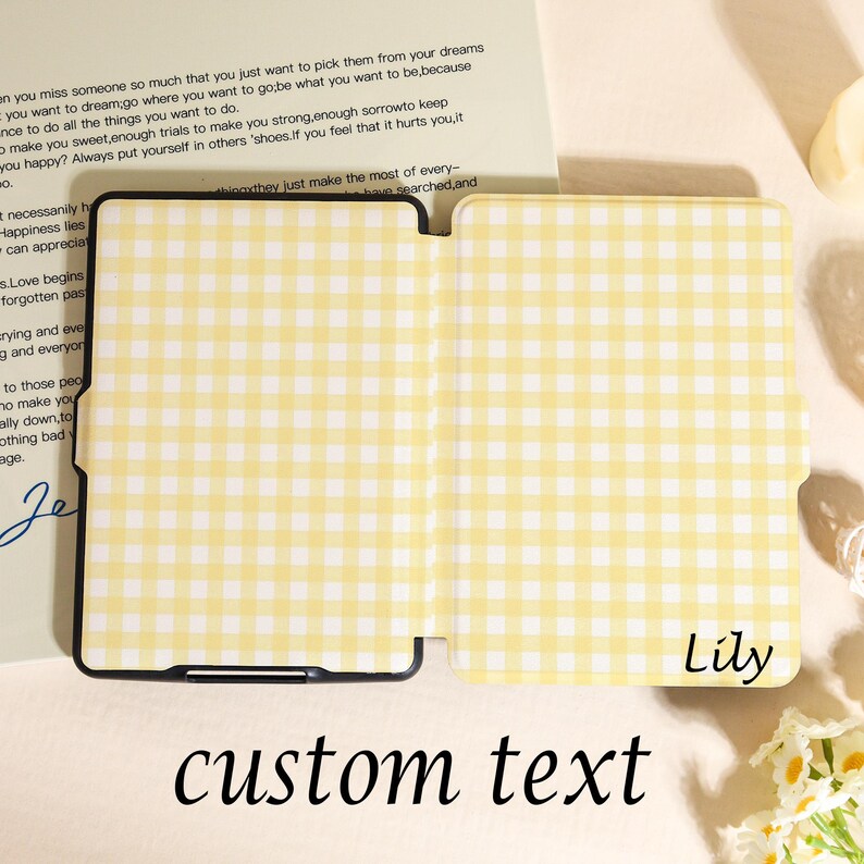 May include: A yellow and white gingham pattern tablet case with the word "Lily" in the corner and the words "custom text" at the bottom. The case is open, revealing the interior. A handwritten note is in the background.
