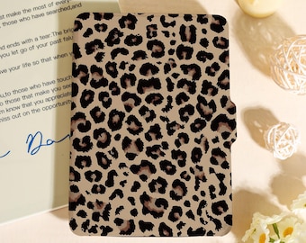 May include: A tan and brown leopard print case. The case has a magnetic closure and is designed to hold a tablet or e-reader. The case is made of a durable material and features a classic animal print design. The case is a stylish accessory for protecting electronic devices.